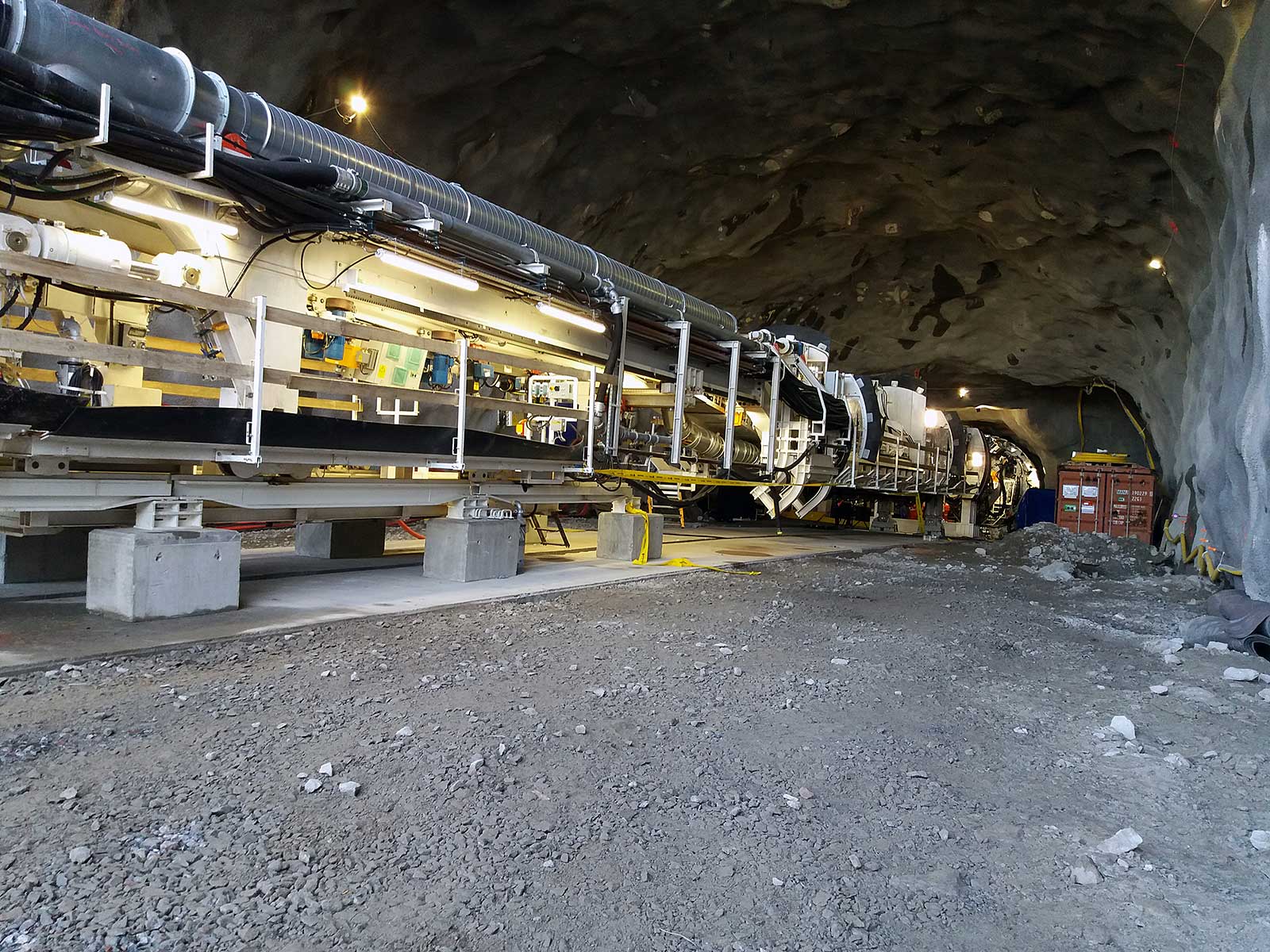 Tunnel boring machine (TBM) at work. TBMs are used to build large tunnels, for example for motorways, railways and underground railways. The machine drills through the rock and removes the excavated material at the same time.